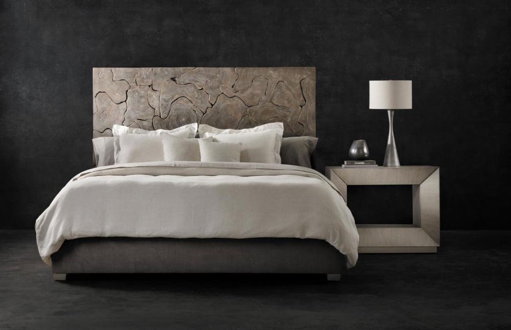 a bed with a lamp on the side