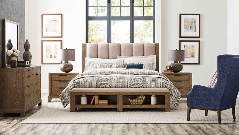 a living room with a bed and a chair